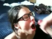 Beautiful nerdy chick receives cum all over her face